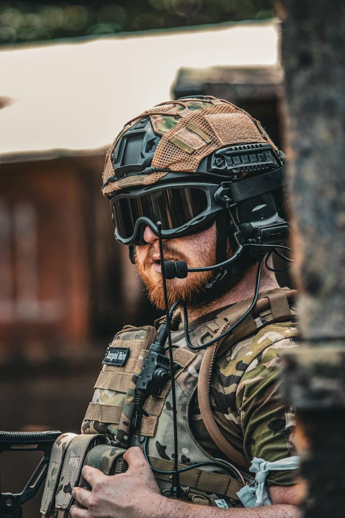 Portrait of a soldier in full tactical uniform and helmet outdoors.